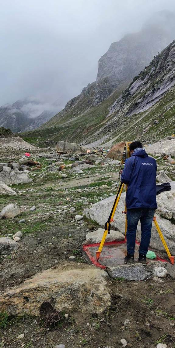 HSSPL surveyor observing with a total station in a high-altitude valley