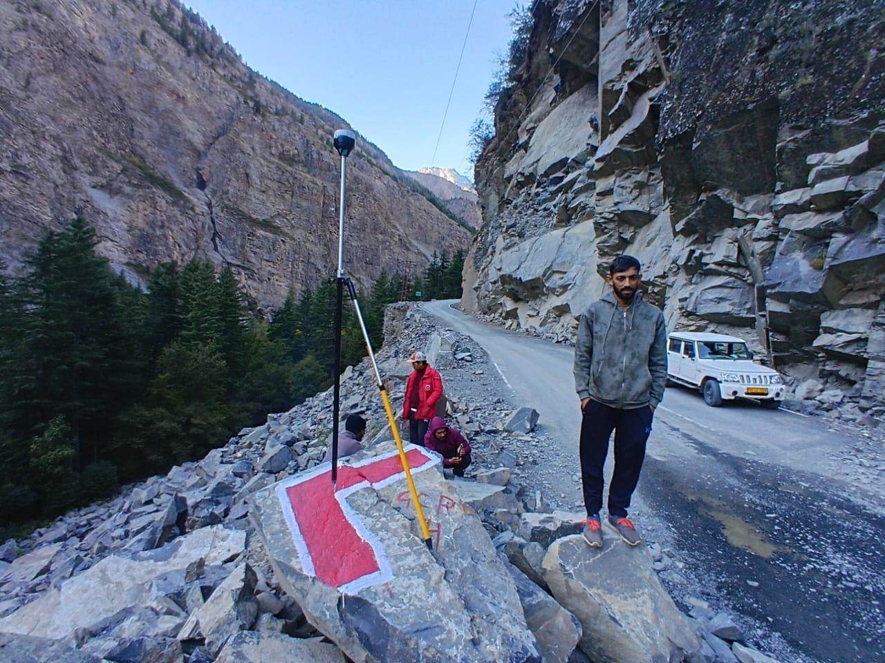 Survey crew establishing a control point on a gorge road alignment