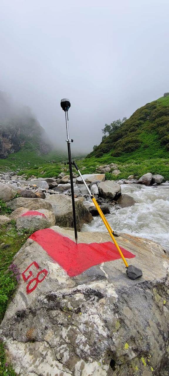 GNSS receiver on a control point beside a torrent in monsoon fog